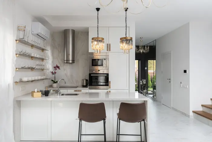 Cuisine blanche lumineuse avec îlot et tabourets